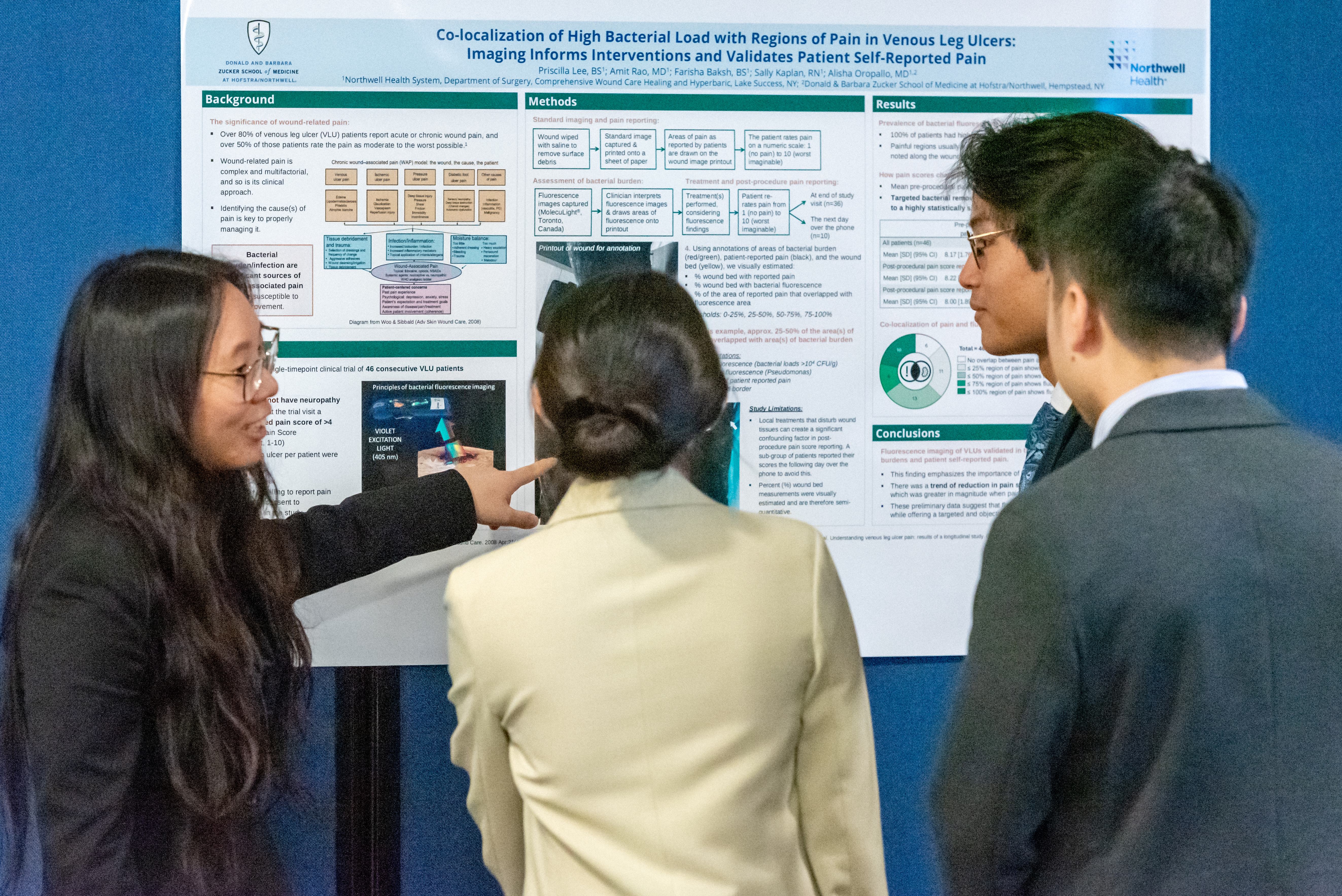 Students reviewing research poster