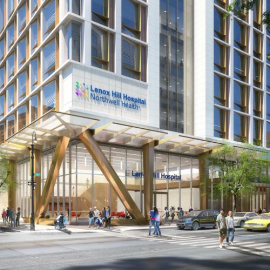 Lenox Hill Hospital Northwell Health sign, large glass windows, people walking outside, cars parked along the street, and trees lining the sidewalk on a sunny day.