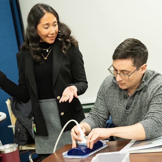 faculty with student doing ultrasound