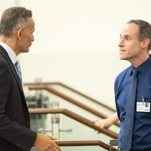 two faculty members talking
